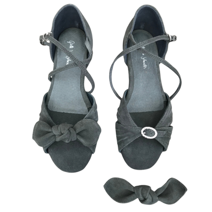 Pair of gray high-heeled shoes with bow details on a white background