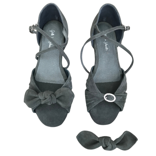 Pair of gray high-heeled shoes with bow details on a white background